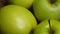 Four green apples, macro video. Apples of the Reinette Simirenko variety.