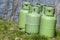 Four green propane storage bottles