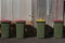 Four green rubbish bins in lane