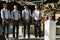 Four groomsmen with the bow-ties on the wedding ceremony