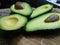 Four halves of organic avocadoes