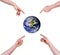 Four hands pointing fingers at planet earth