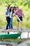 Four happy smiling friends have fun on pier on summer outdoors background