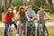 Four happy teenage friends riding bicycles