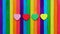 Four hearts in multiple colors on colorful ice-cream sticks line up as rainbow flag.