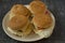 Four homemade burgers on a plate top view