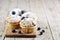 Four homemade fresh muffins with blueberries on rustic wooden table background