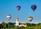 Four hot air balloons above the Boise Train Depot