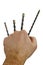 Four impact drill bits held in raised fist of adult male person, white background