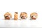 Four Japanese maki sushi rolls in a row with salmon, sesame and cream cheese  isolated on white background. Side view