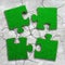 Four jigsaw puzzles with green grass
