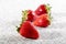 Four juicy strawberry on granite background