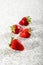 Four juicy strawberry on granite background