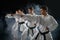 Four karate fighters poses in white kimono
