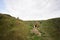 Four kids explore limestone stone cave at mountain