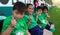 Four kids salutes to the camera in a sport event in mexico