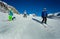 Four kids ski downhill in the mountains together