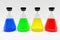 Four laboratory flasks with colorful blue yellow green red liquids.