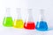 Four laboratory flasks with colorful liquids