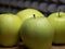 Four large apples, close-up. Fruit on a wooden surface