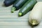 Four large zucchini on a wooden background. Copy space