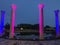 Four lighted pillars by water