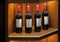 Four luxury red vine bottles on the shelf