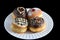 Four luxury sufganiyot with different icing on a white plate