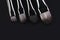 Four makeup brushes close-up on a black background. horizontal