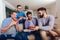 Four male friends eating pizza at home