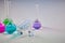 Four medical flasks with colorful chemical reagents. Seven mockup ampoules with transparent liquid and syringe isolated