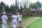 Four Member of Balinese Family Wearing White Clothing Going To Hindu Temple for Praying Bringing Sesajen on The Basket