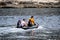 Four men at sea on a small inflatable motor boat