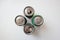 Four metal drink cans on white background from above