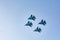 Four military planes in the sky are showing a show. Military fighters Su-30 SM. Bombers fly in the sky