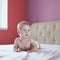 Four-month baby lying in bed