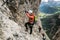 Four mountain climbers on a Via Ferrata in the Dolomites in Alta Badia