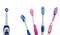 Four multi-colored manual toothbrushes and one electric