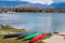 Four multi-colored overturned boats on the shore of the lake