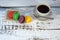 Four multi-colored pasta on a wooden table and a cup of black coffee. Close-up