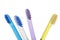 Four multi-colored toothbrushes in a blue glass