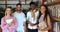 Four multi-ethnic students posing for camera in university library