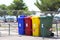 Four multicolored boxes for sorted garbage: red, green, blue and yellow. Recycling garbage in the tourist area. Infrastructure of