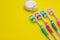 Four multicolored toothbrushes and dental floss over white background