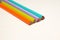 The four multicolour wooden pencils background on the white