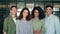 Four multiracial business startup coworkers standing in contemporary office.