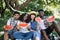 Four multiracial sitting at garden with slices of watermelon