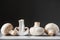 Four mushrooms champignons lie in a row on a white table on a dark background. Place for text or advertising. Design border