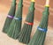 Four new green broom for cleaning foliage.