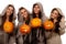 Four nuns holding halloween pumpkins